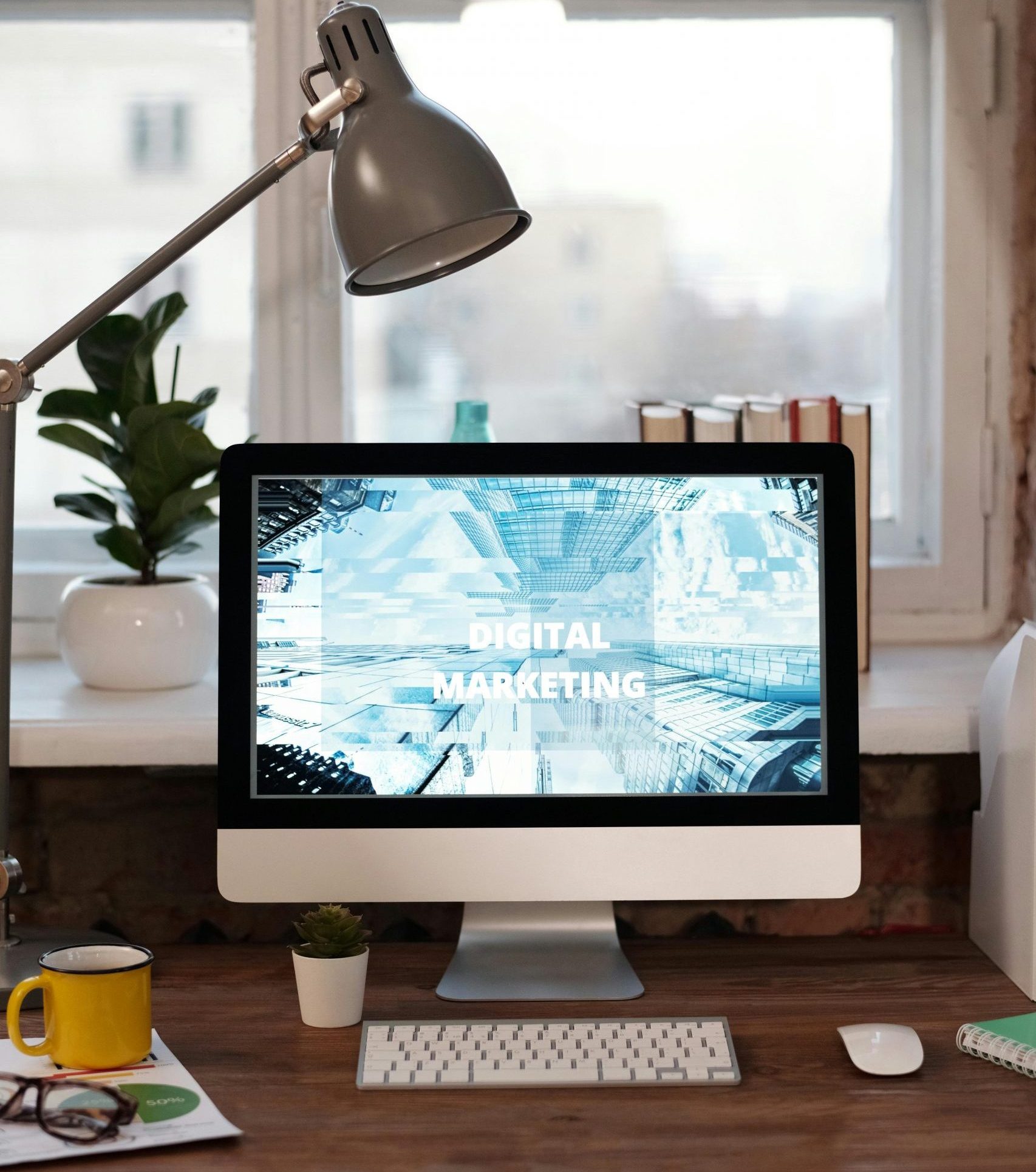Contemporary home office desk with digital marketing screen, perfect for remote work inspiration.